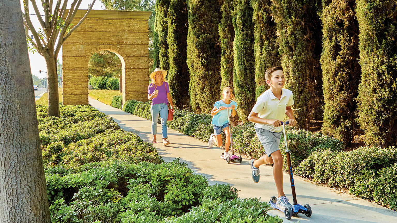 family walking down sidewalk