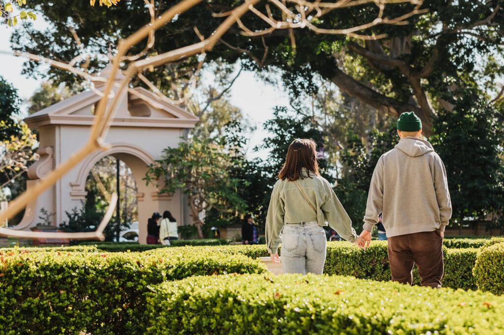 A couple strolling through a village garden